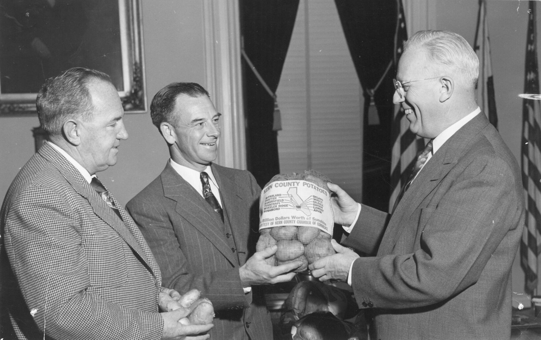 5 - Governor Earl Warren recieving or giving away Kern County Potatoes.jpg